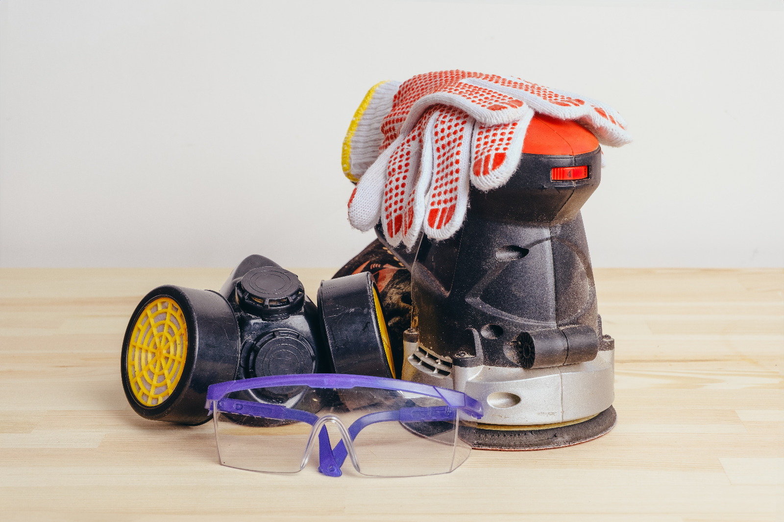 Sanding Parquet Floors in Sydenham – PPE setup with respirator, safety glasses, gloves and a random orbital sander ready for herringbone oak parquet work.
