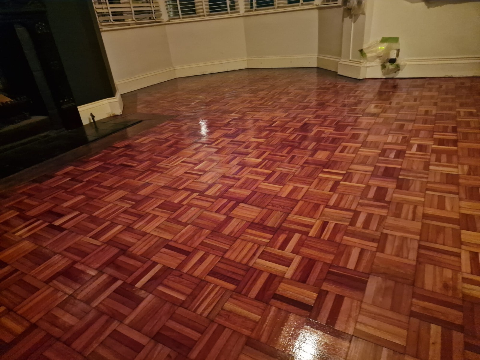Wood Floor Sanding in Sydenham on oak mosaic parquet flooring with a rich polished finish in a living room