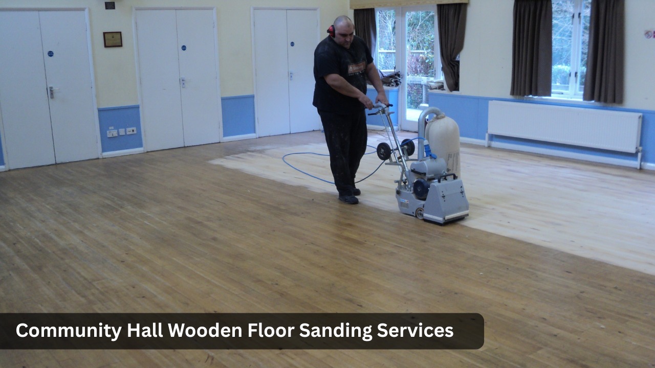 Professional floor sanding in progress at a community hall – worker using a dust-extraction sanding machine on wooden floorboards, showing the contrast between old and freshly sanded sections